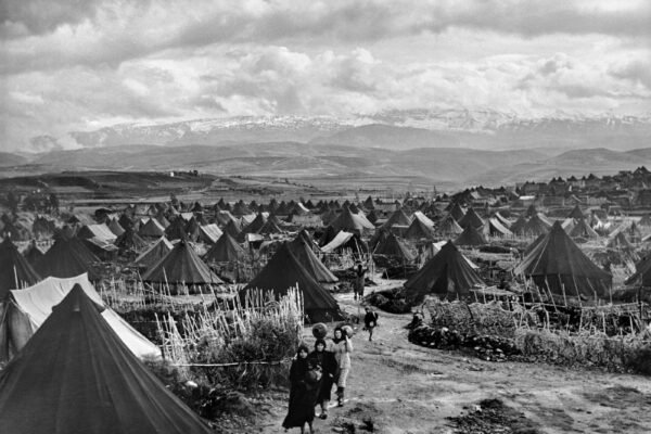 UNRWA Photo No. RL-Nahr El-Bared-1, Nahr el Bared camp near Lebanon(1952) was one of the first camps that was part of the emergency measures to shelter the Palestine refugees of the Arab-Israeli conflict in 1948.The six thousand refugees lived in the tents in Nahr-el Bared camp.Later,tents were replaced by concrete huts for the 25000 residents living there.credit:UNRWA Photo by S.Madver 1951